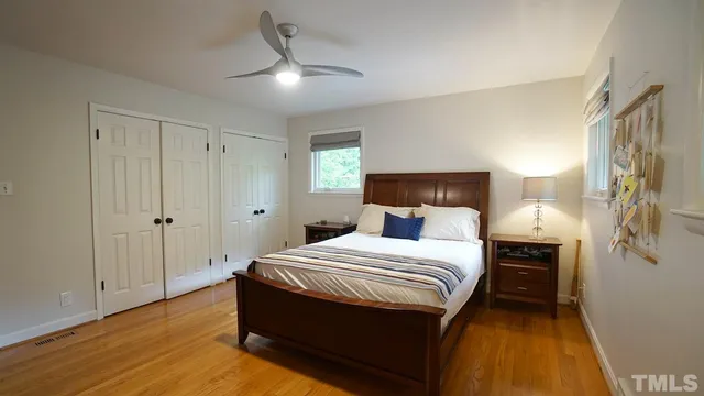 a bedroom with a bed and a lamp