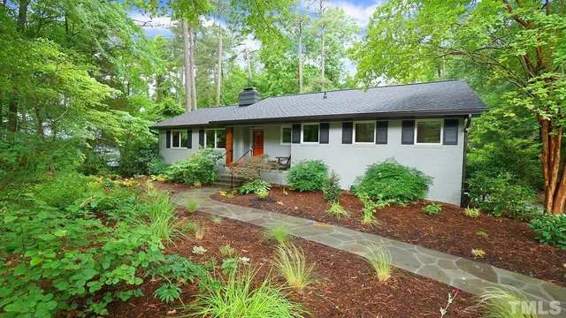 a front view of a house with a garden