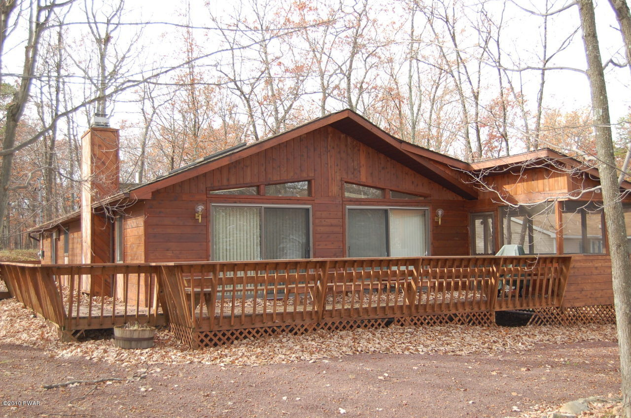 a front view of a house with wooden fence
