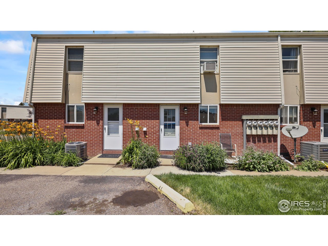 215 Chestnut Street, Unit A5 Windsor, CO 80550 - Photo 17 of 18 a black and white house with a yard