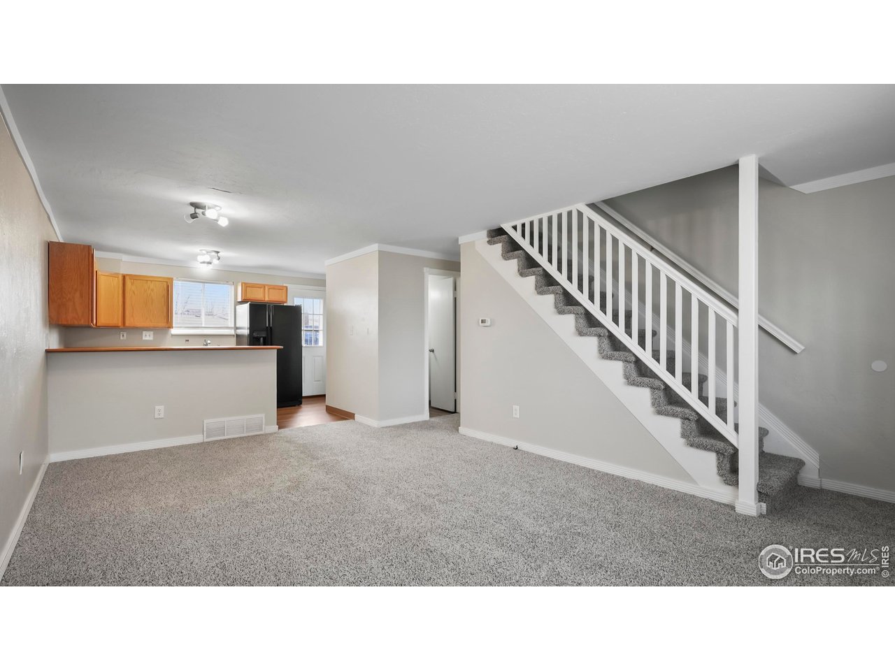 215 Chestnut Street, Unit A5 Windsor, CO 80550 - Photo 5 of 18 a open hall with stairs