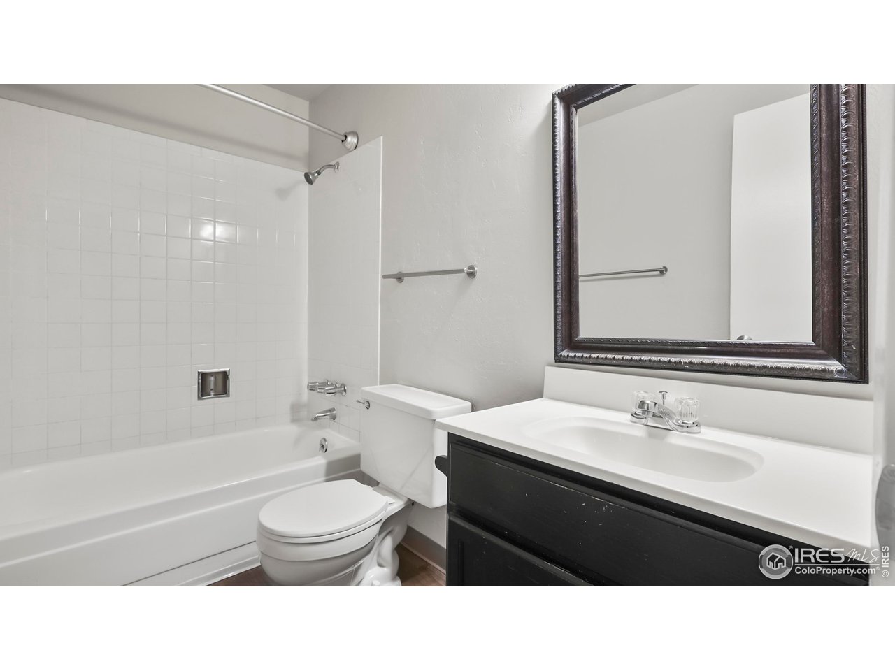 215 Chestnut Street, Unit A5 Windsor, CO 80550 - Photo 10 of 18 a bathroom with a sink a toilet a mirror and shower