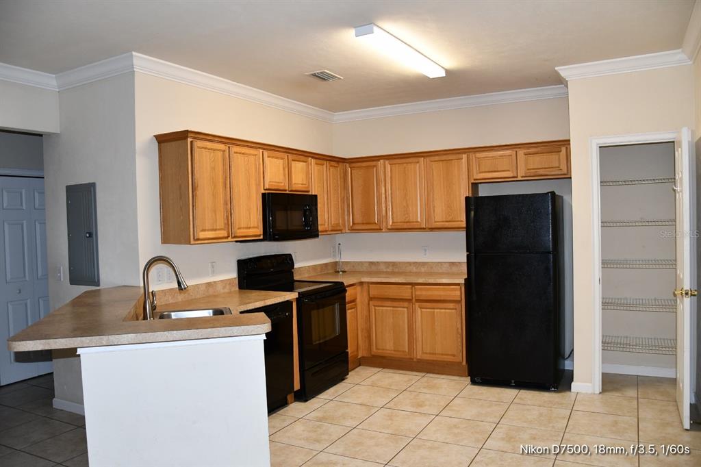 2165 Northwest 10th Street, Unit D Gainesville, FL 32609 - Photo 2 of 12 a kitchen with a sink a stove and refrigerator