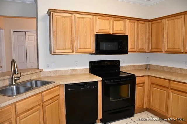 a view of an empty room with a chandelier fan