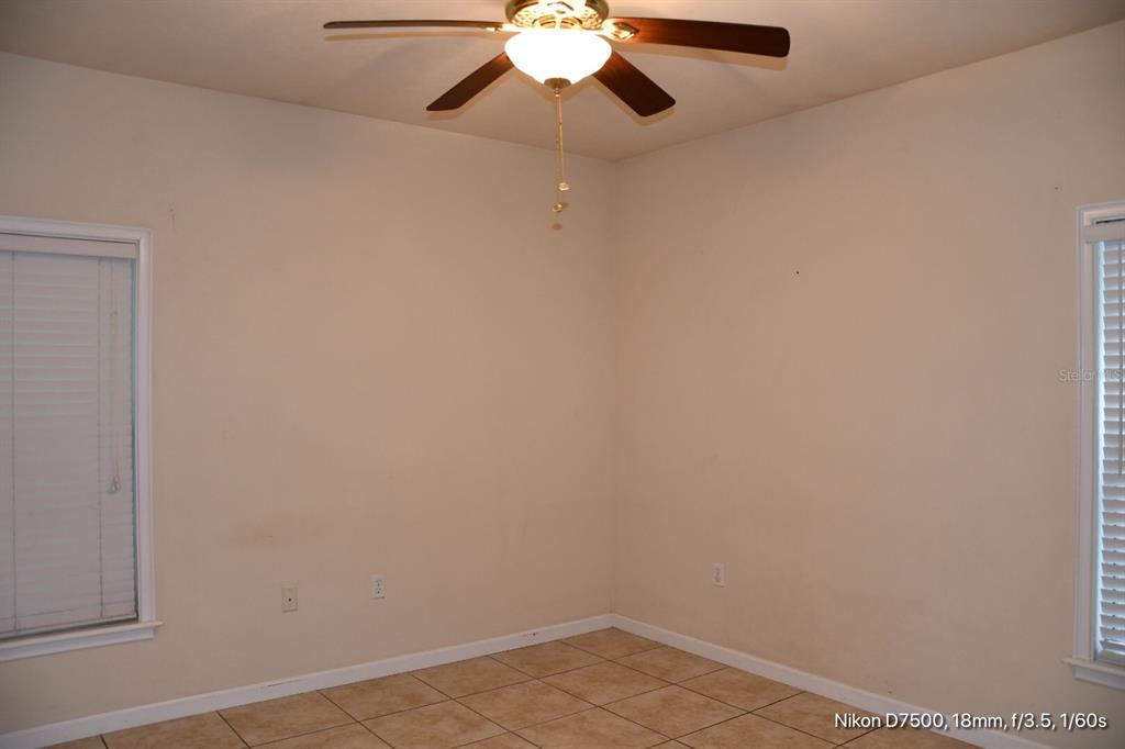 2165 Northwest 10th Street, Unit D Gainesville, FL 32609 - Photo 5 of 12 a view of an empty room with a chandelier fan