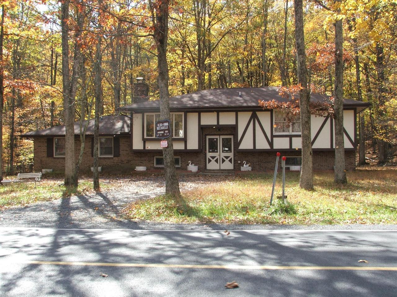 28 Decker Road Bushkill, PA 18324 - Photo 1 of 10 a view of a house with backyard porch and sitting area