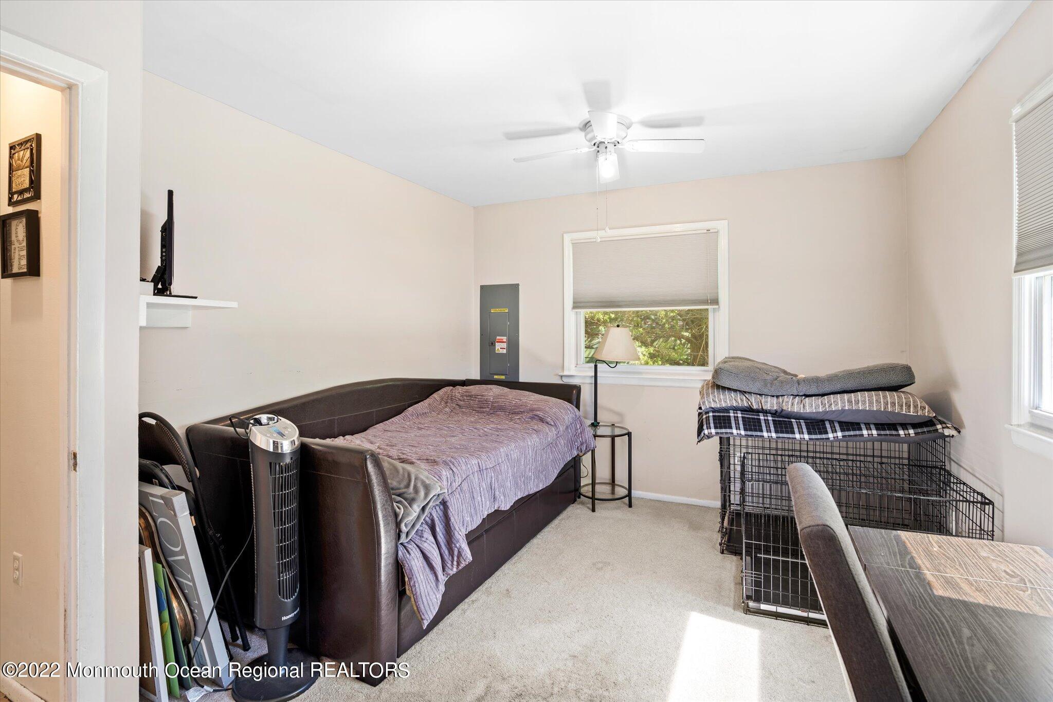 2 Sunset Drive Howell, NJ 07731 - Photo 29 of 41 a bedroom with a bed and a chandelier