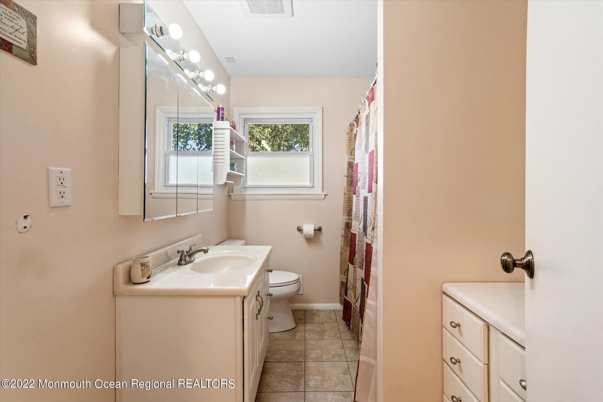 2 Sunset Drive Howell, NJ 07731 - Photo 3 of 41 a bathroom with a sink mirror and a window