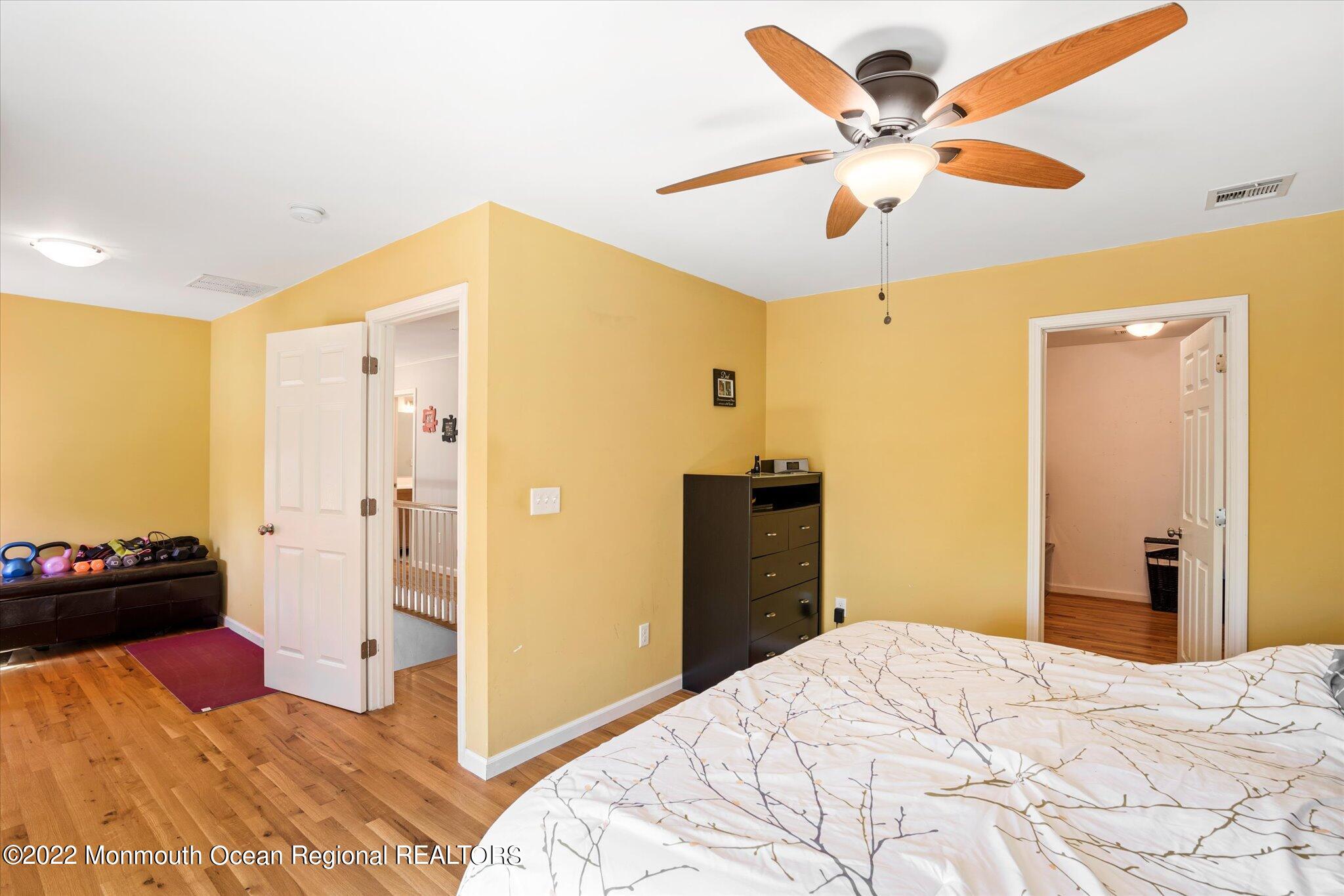 2 Sunset Drive Howell, NJ 07731 - Photo 32 of 41 a bedroom with a bed and a chandelier