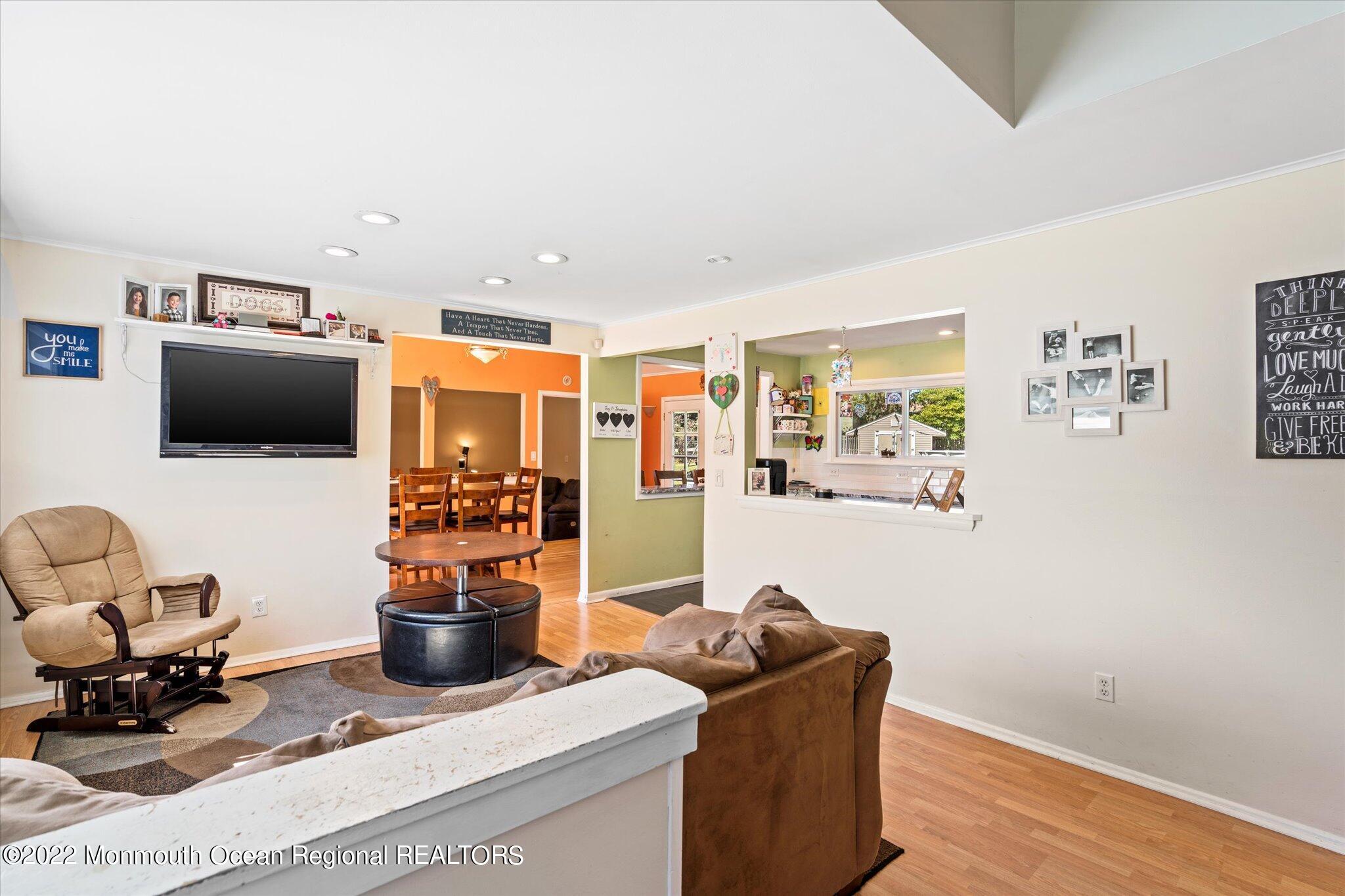 2 Sunset Drive Howell, NJ 07731 - Photo 37 of 41 a living room with furniture a flat screen tv and kitchen view