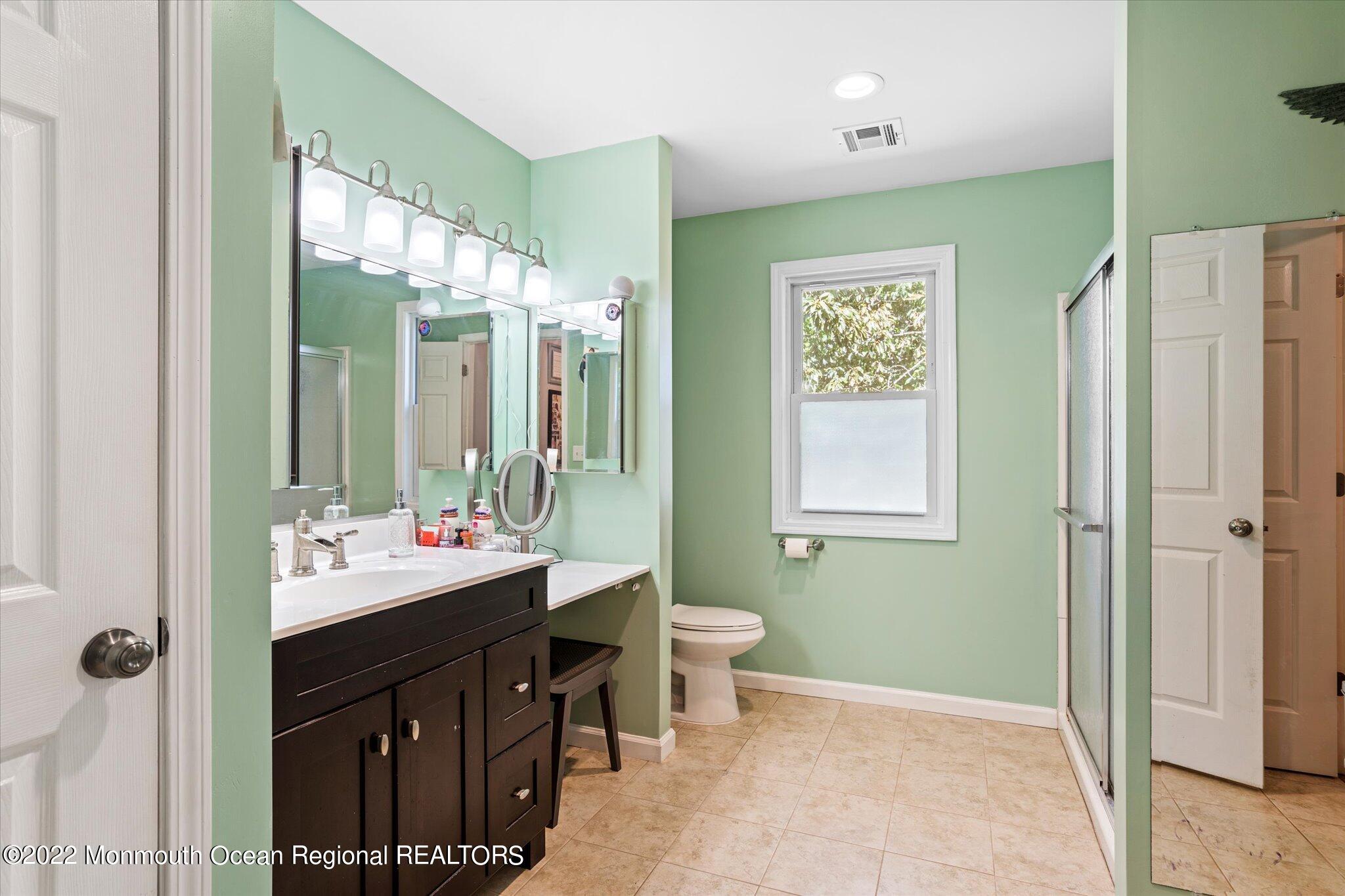 2 Sunset Drive Howell, NJ 07731 - Photo 6 of 41 a bathroom with a double vanity sink a mirror and a shower
