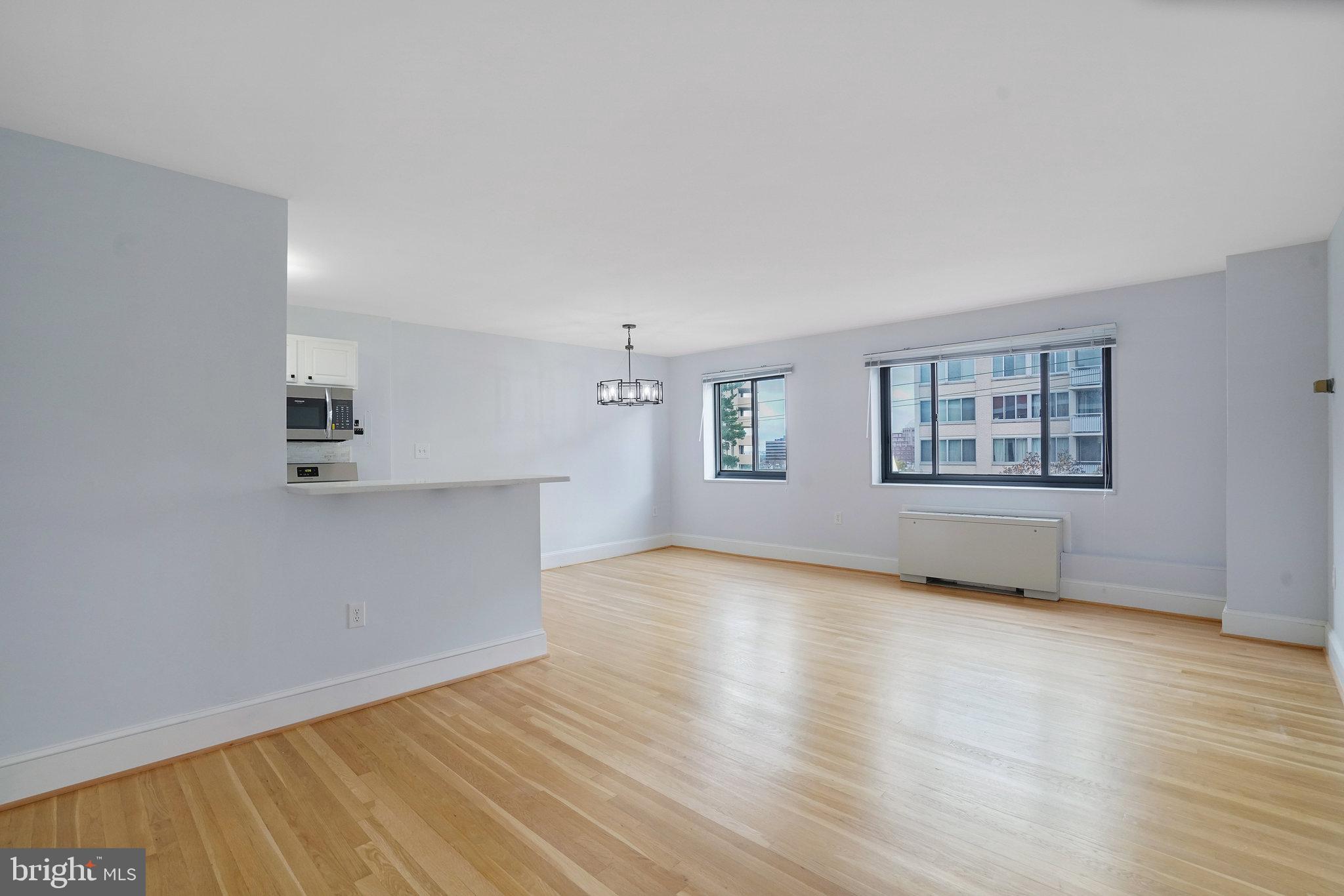 1200 South Arlington Ridge Road, Unit 612 Arlington, VA 22202 - Photo 15 of 27 an empty room with wooden floor and windows