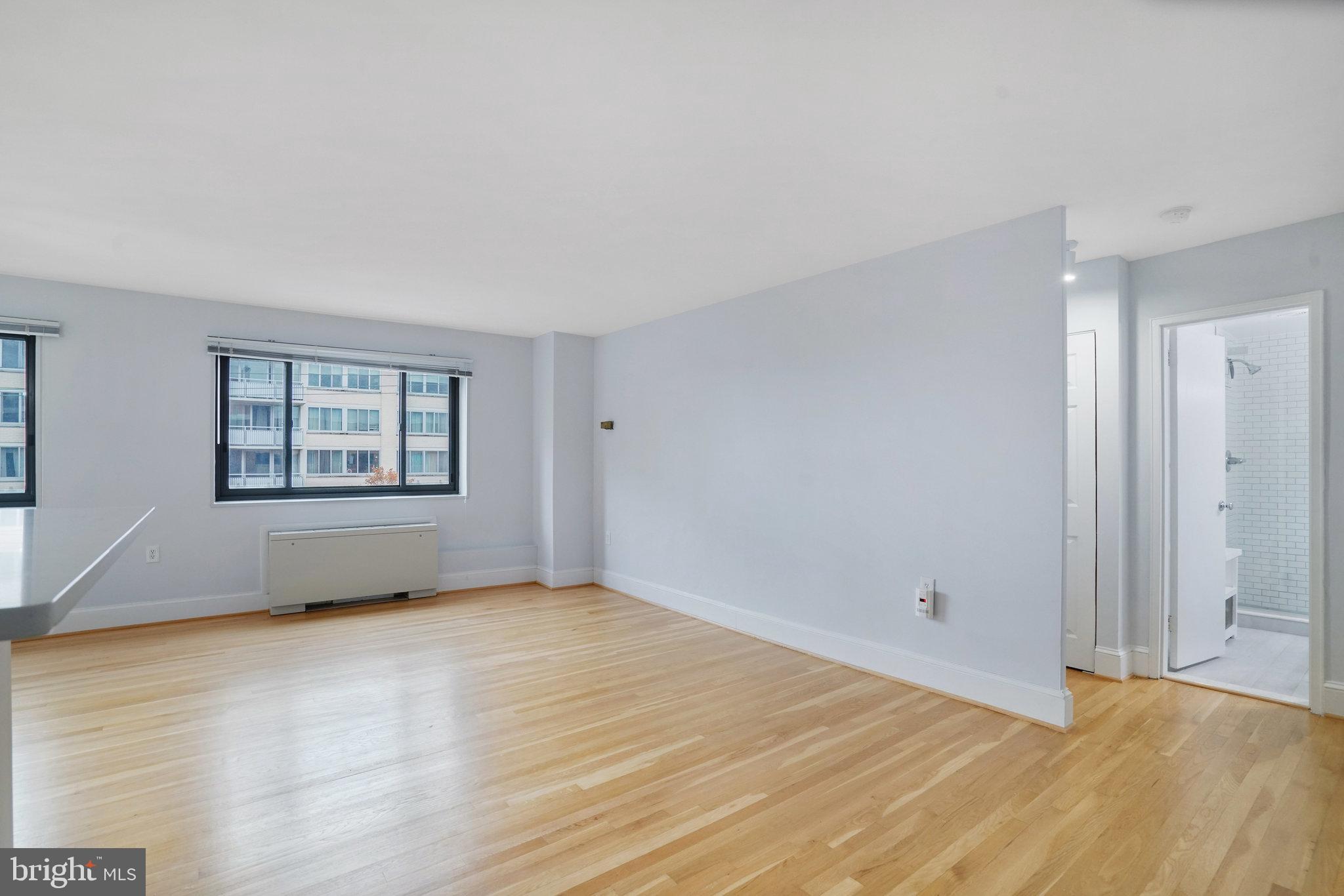 1200 South Arlington Ridge Road, Unit 612 Arlington, VA 22202 - Photo 16 of 27 a view of an empty room with wooden floor and a window