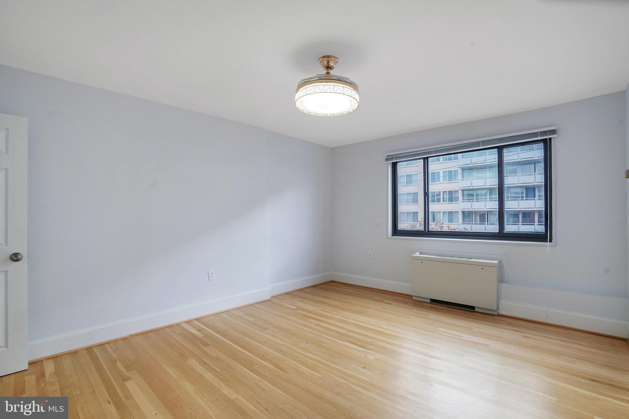 1200 South Arlington Ridge Road, Unit 612 Arlington, VA 22202 - Photo 20 of 27 an empty room with wooden floor and windows