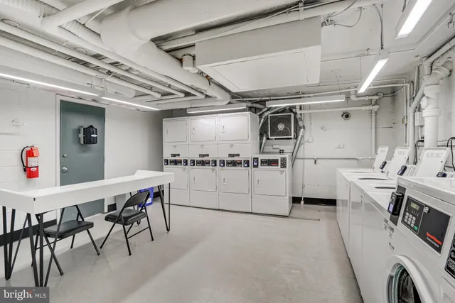 a utility room with cabinets dryer and washer