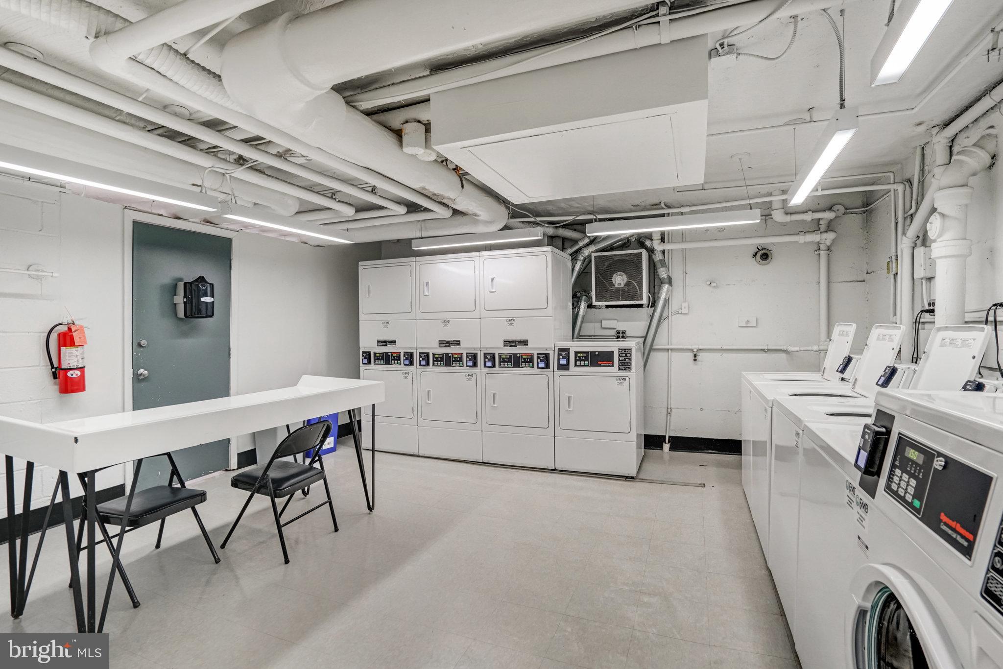 1200 South Arlington Ridge Road, Unit 612 Arlington, VA 22202 - Photo 24 of 27 a utility room with cabinets dryer and washer
