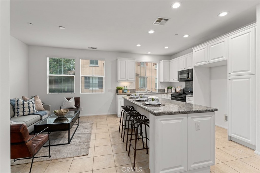 8483 Kendra Loop Orange, CA 92867 - Photo 8 of 30 a kitchen with a stove a refrigerator and wooden cabinets