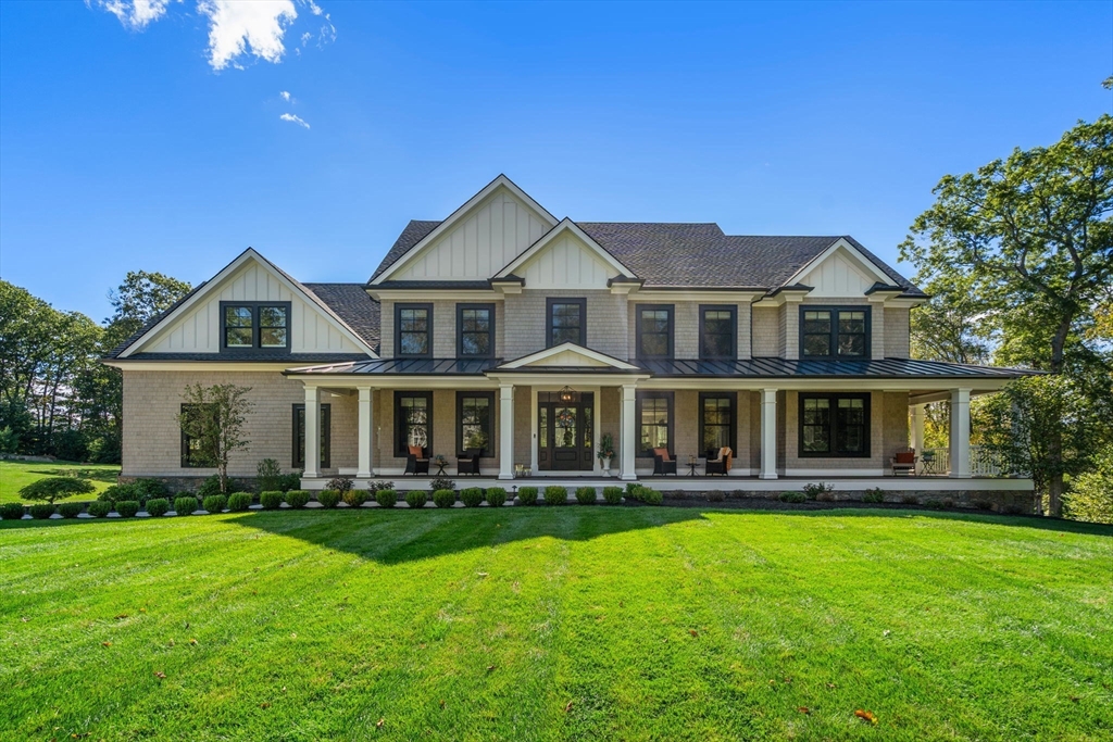 a front view of a house with a yard table and chairs