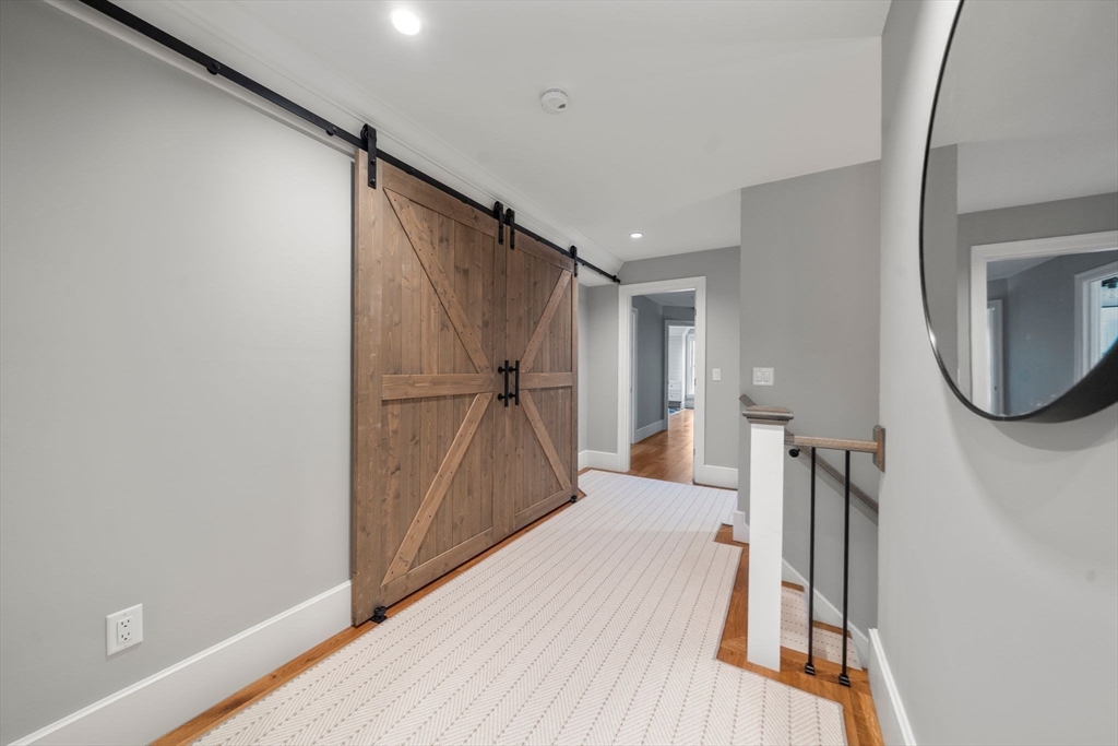 9 Wedge Way Rehoboth, MA 02769 - Photo 21 of 42 a walk in closet with wooden floor and a bathroom