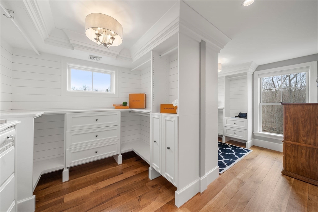 9 Wedge Way Rehoboth, MA 02769 - Photo 22 of 42 a hallway with a dresser and a chandelier