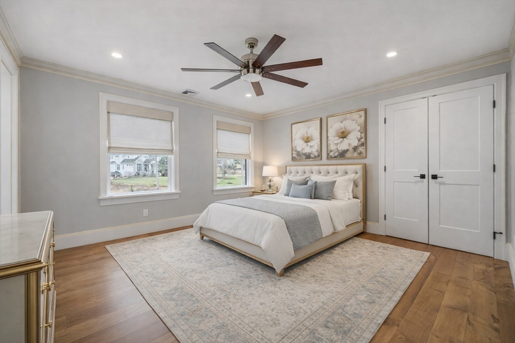 9 Wedge Way Rehoboth, MA 02769 - Photo 27 of 42 a spacious bedroom with a large bed chandelier and a window