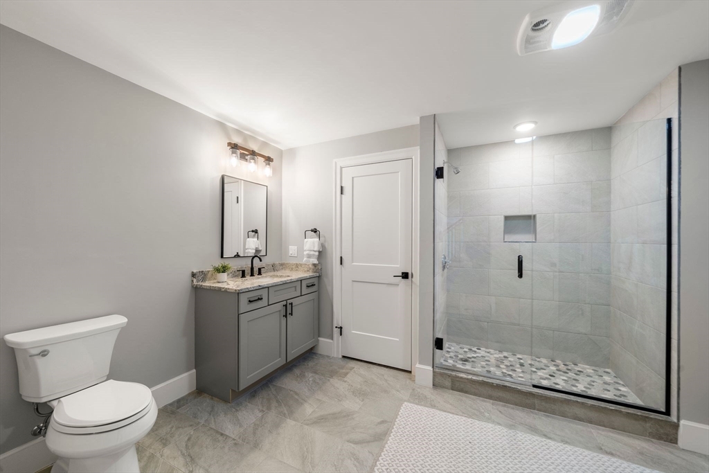 9 Wedge Way Rehoboth, MA 02769 - Photo 32 of 42 a bathroom with a granite countertop sink a toilet and shower