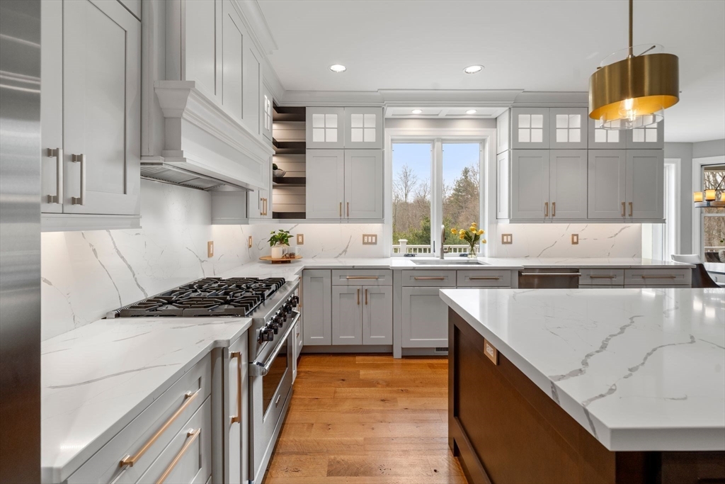 9 Wedge Way Rehoboth, MA 02769 - Photo 7 of 42 a kitchen with a sink stove top oven and cabinets