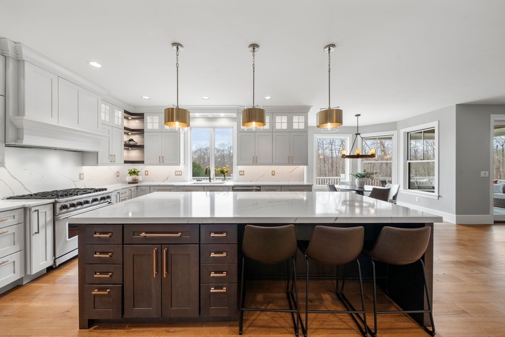 9 Wedge Way Rehoboth, MA 02769 - Photo 8 of 42 a kitchen with stainless steel appliances granite countertop a sink a stove and a wooden floors