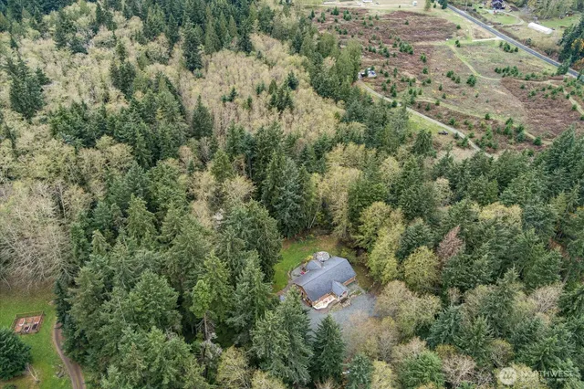 an aerial view of a house with lots of trees
