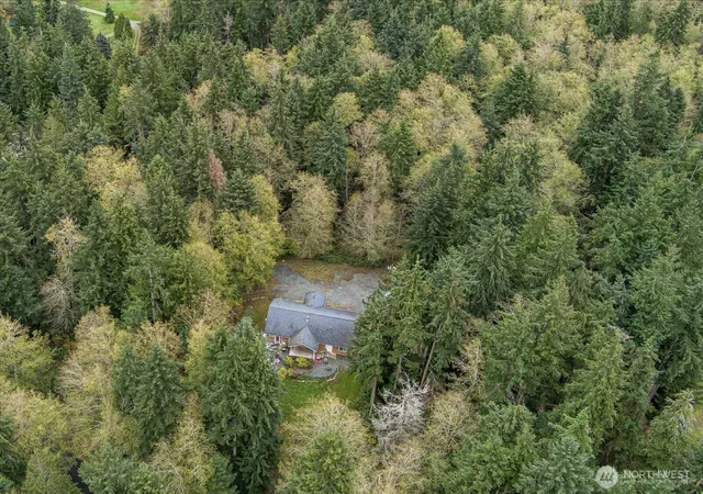 an aerial view of a house with a yard