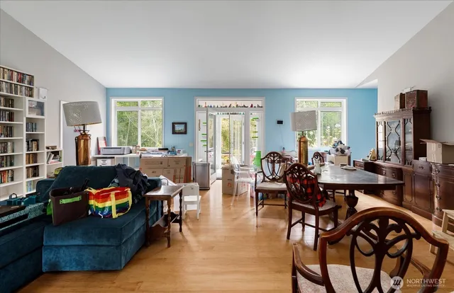 a living room with furniture kitchen view and a large window