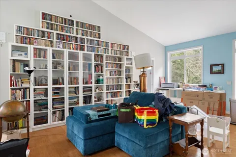 a living room with furniture and a floor to ceiling window
