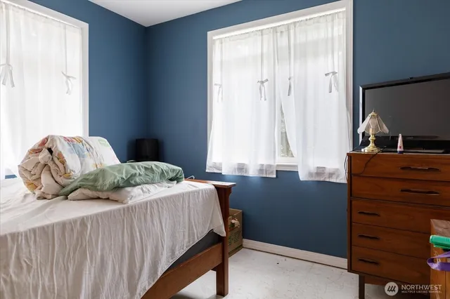 a bedroom with a bed and window