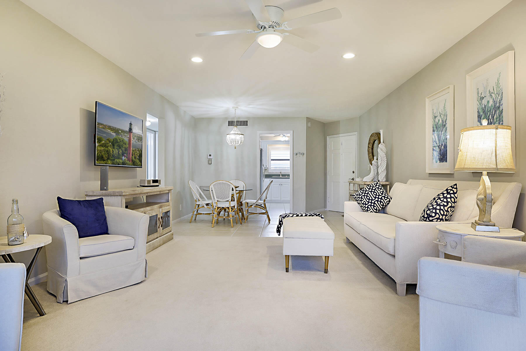 755 Saturn Street, Unit F203 Jupiter, FL 33477 - Photo 15 of 36 a living room with furniture and a wooden floor