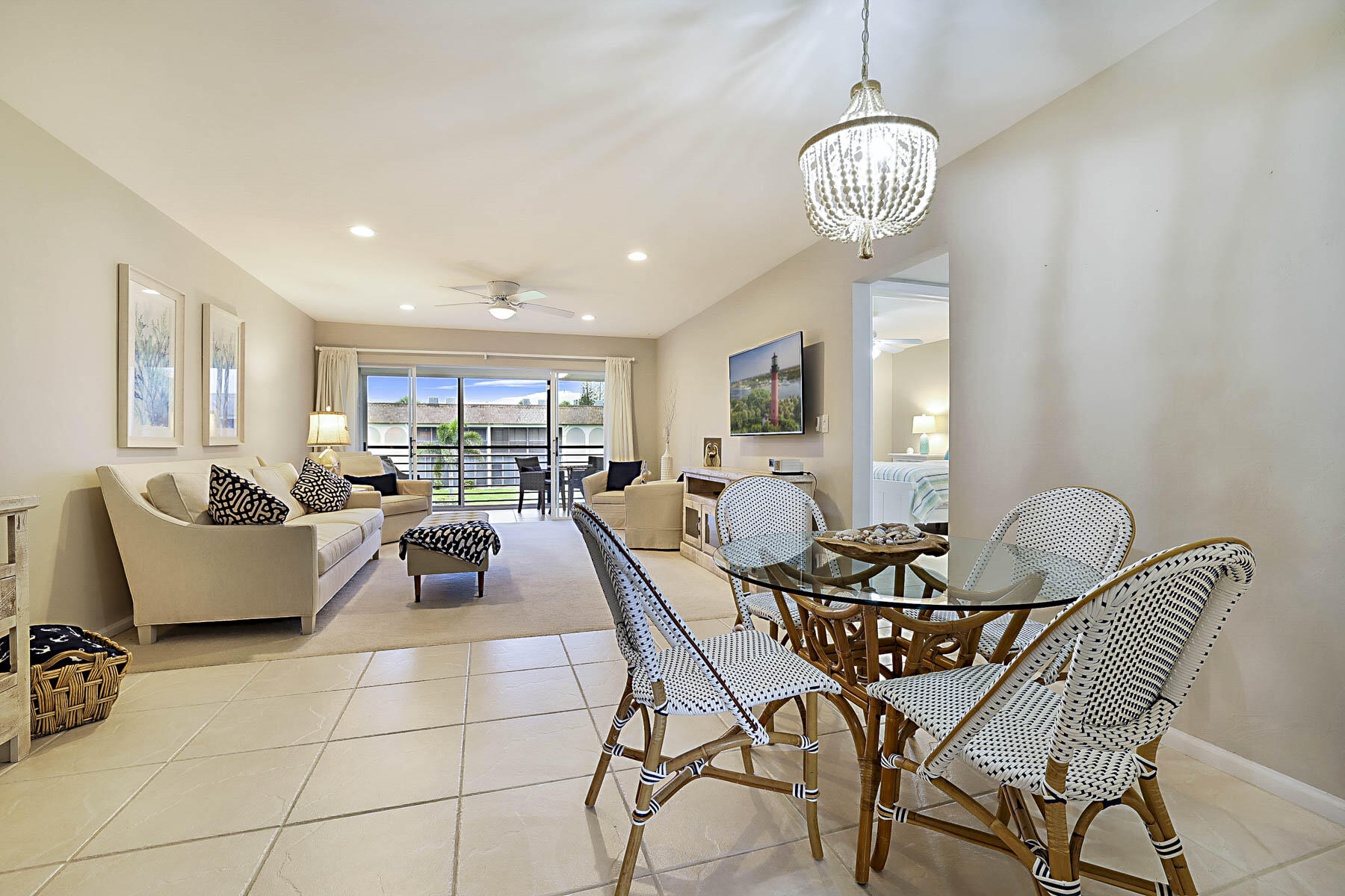 755 Saturn Street, Unit F203 Jupiter, FL 33477 - Photo 18 of 36 a view of a dining room with furniture and chandelier