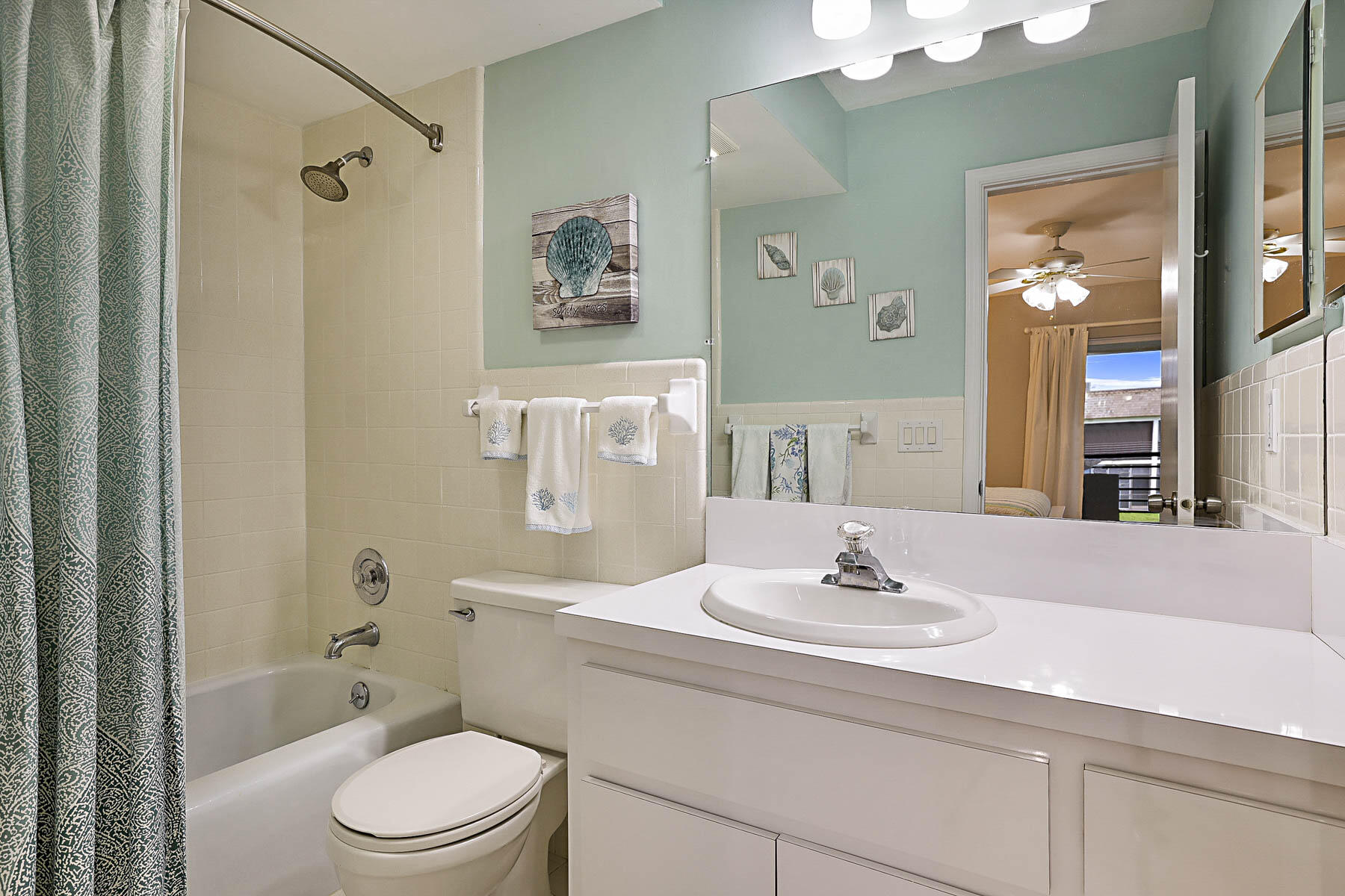 755 Saturn Street, Unit F203 Jupiter, FL 33477 - Photo 29 of 36 a bathroom with a sink a toilet and shower