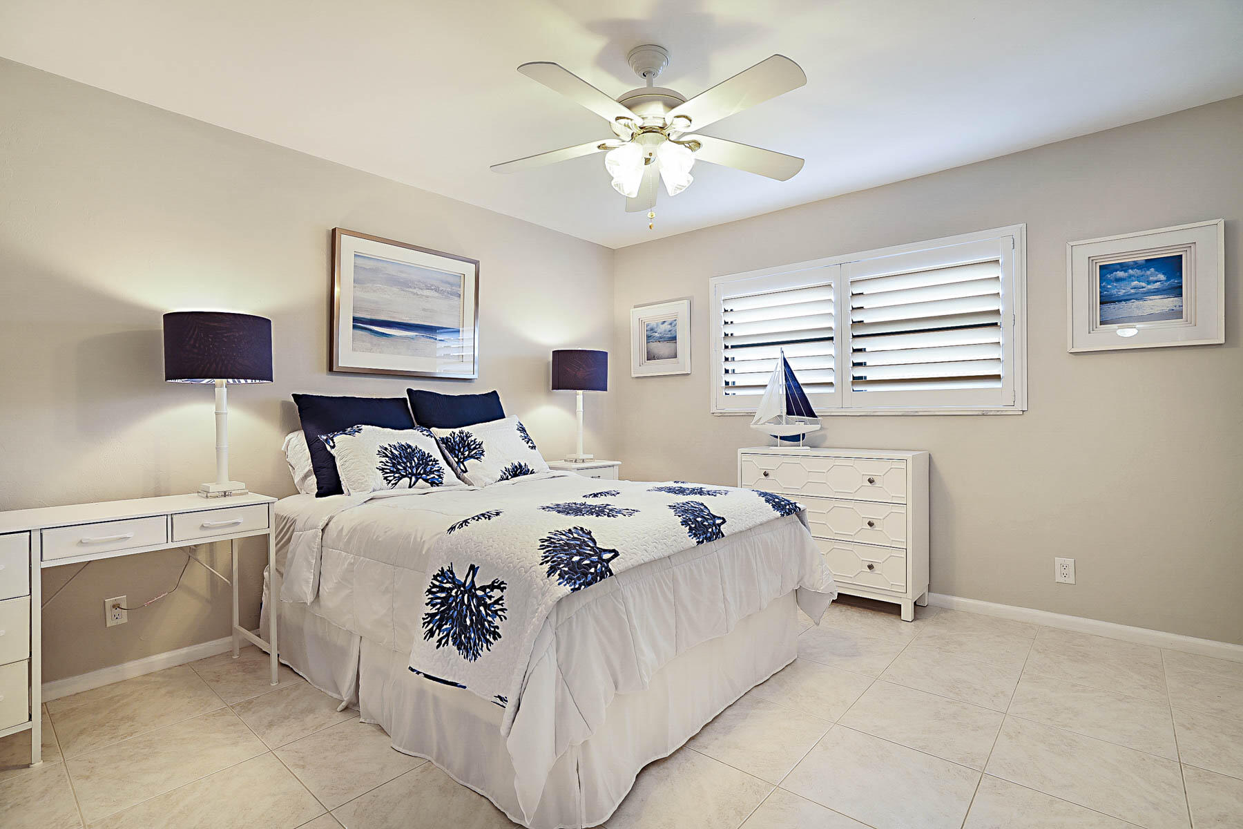 755 Saturn Street, Unit F203 Jupiter, FL 33477 - Photo 30 of 36 a bedroom with a bed and a chandelier