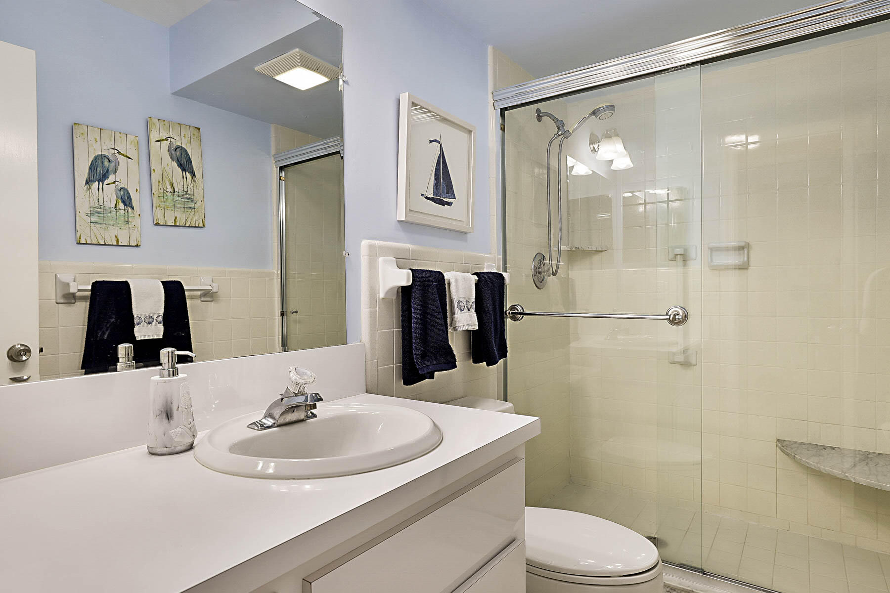 755 Saturn Street, Unit F203 Jupiter, FL 33477 - Photo 32 of 36 a bathroom with a sink toilet and shower