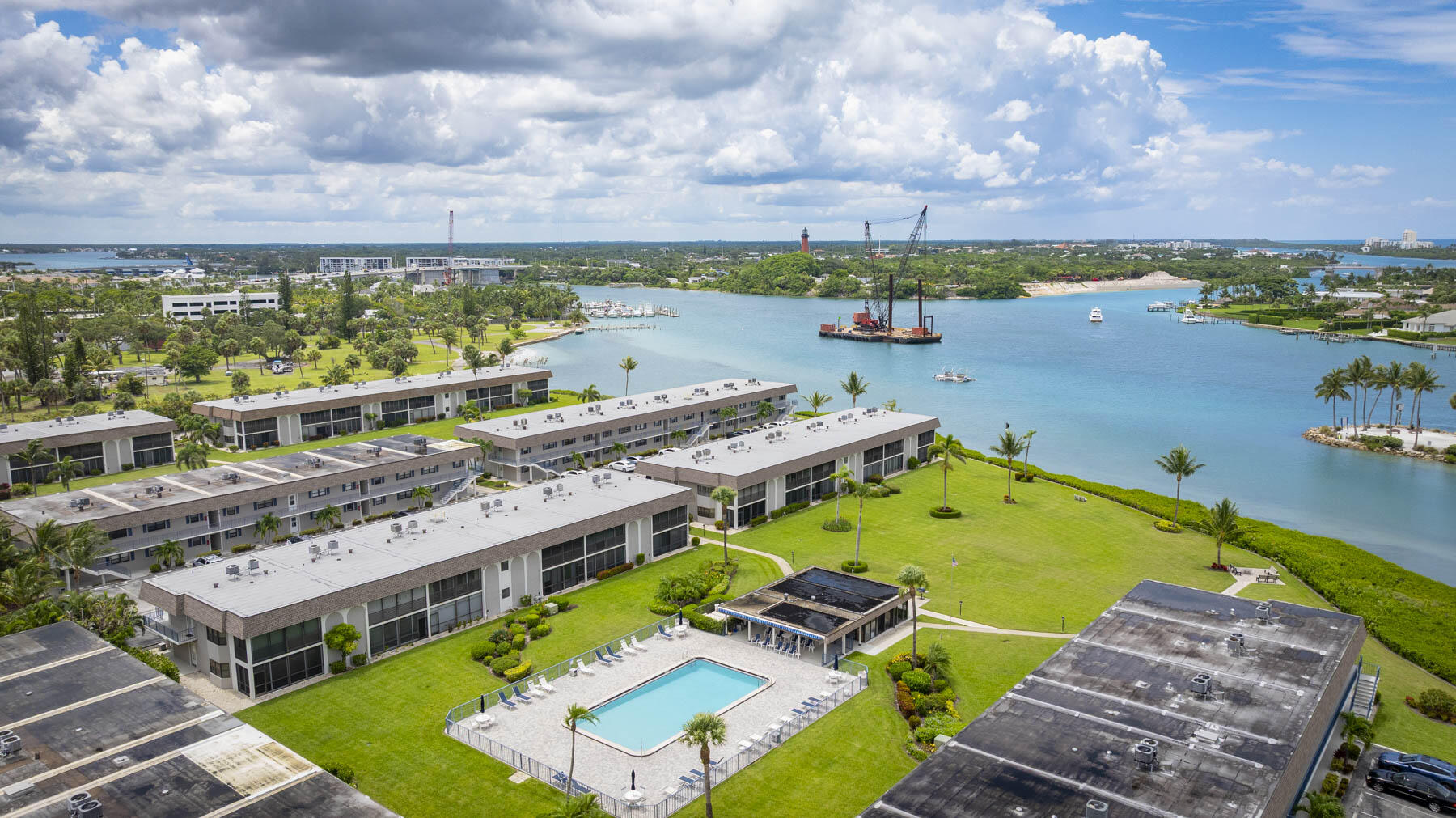 755 Saturn Street, Unit F203 Jupiter, FL 33477 - Photo 4 of 36 a view of a swimming pool with lawn chairs
