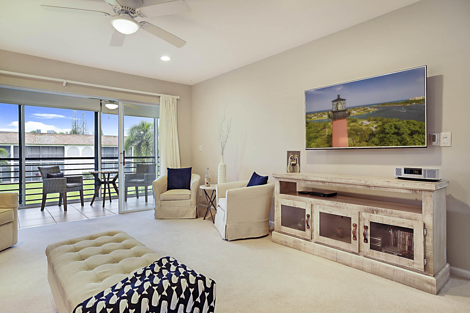 755 Saturn Street, Unit F203 Jupiter, FL 33477 - Photo 8 of 36 a bedroom with furniture and a flat screen tv