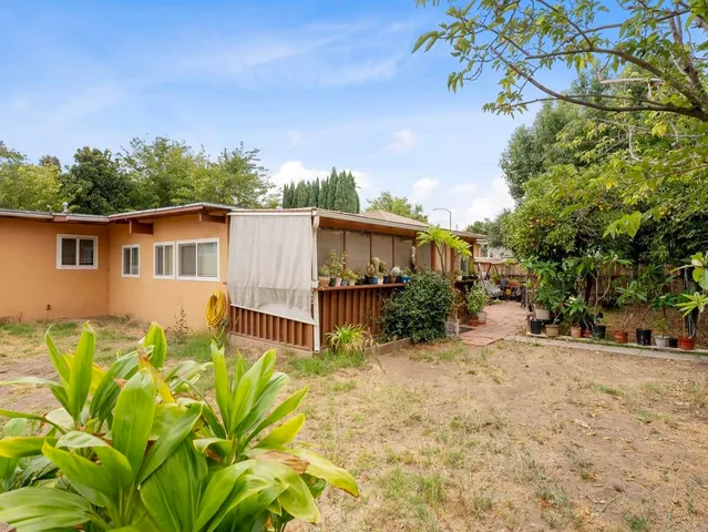 a view of a house with a tree in the background
