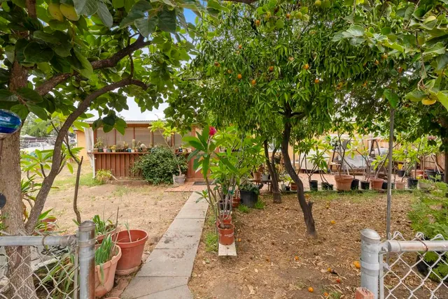 a backyard of a house with table and chairs