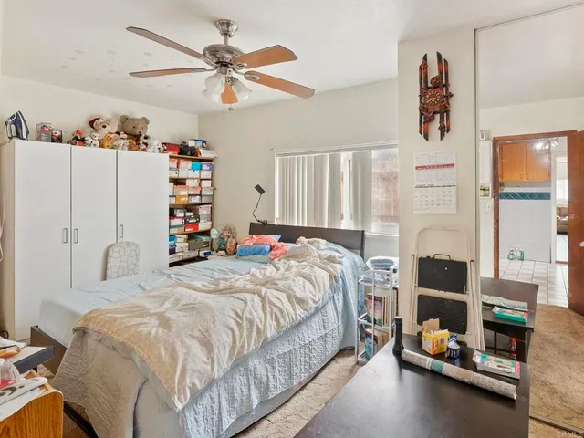 a bedroom with a bed and a window