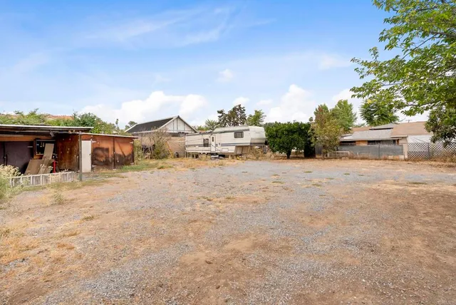 a view of a house with wooden fence