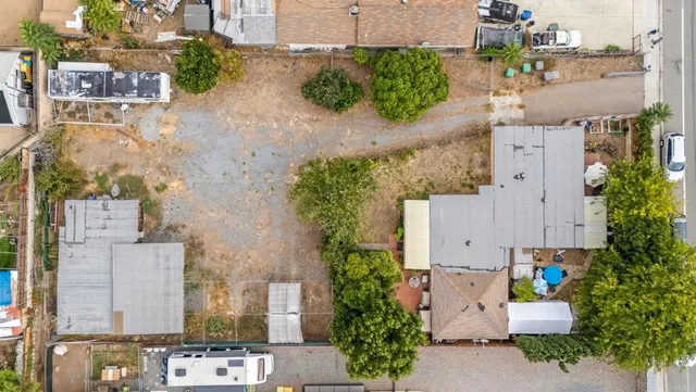 an aerial view of residential houses with outdoor space