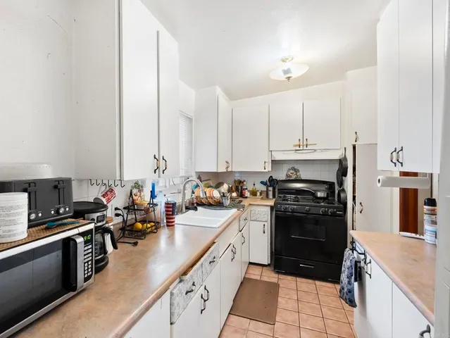 a kitchen with stainless steel appliances a stove sink and cabinets