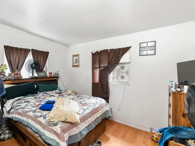 a bedroom with a bed and dresser