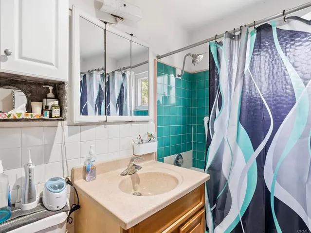a bathroom with a sink mirror and toilet