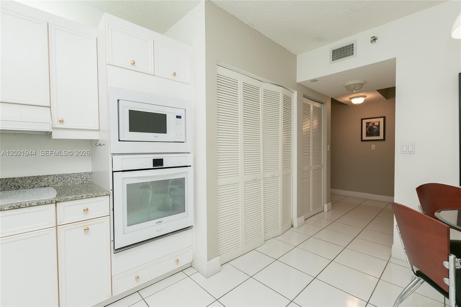8855 Collins Avenue, Unit 6F Surfside, FL 33154 - Photo 15 of 26 Laundry behind the folding doors