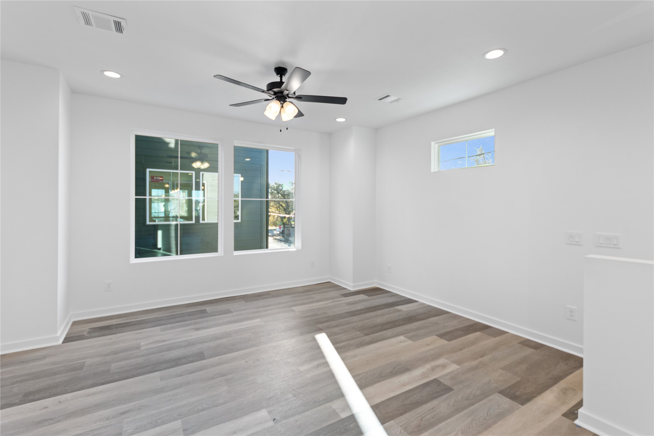 2702 Winbern Street, Unit A Houston, TX 77004 - Photo 12 of 16 a view of an empty room with a window and wooden floor